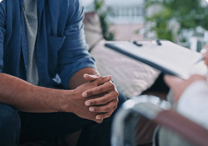 Person sitting during a therapy session.